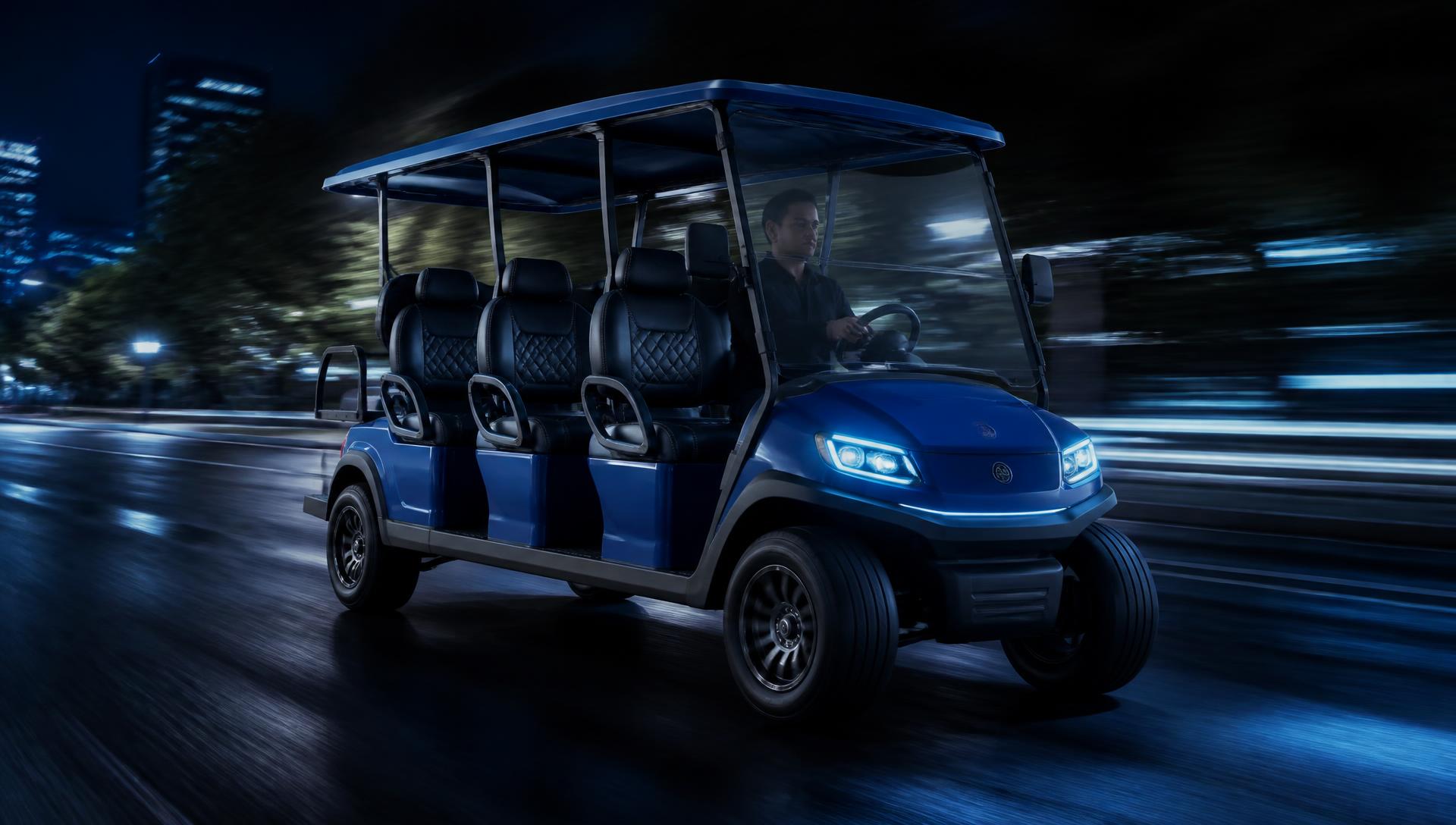 Blue six passenger electric golf cart driving at night
